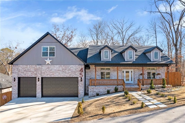 view of front of home featuring a porch and a garage