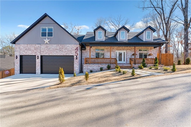 view of front of property with a porch and a garage