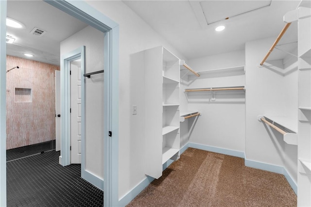 spacious closet with dark carpet