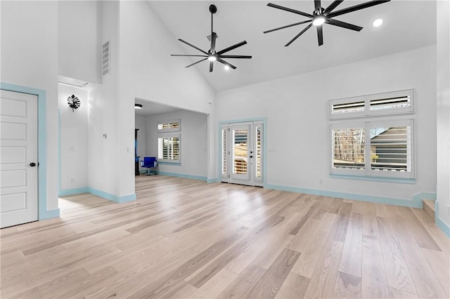 unfurnished living room featuring ceiling fan, light hardwood / wood-style floors, and high vaulted ceiling