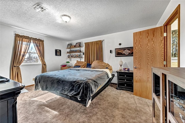 bedroom with light colored carpet and a textured ceiling