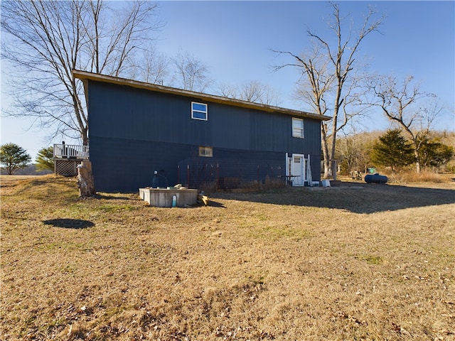 back of house with a lawn