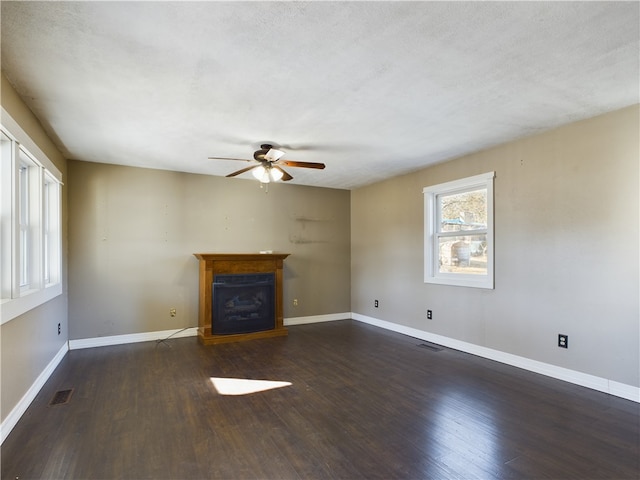 unfurnished living room with ceiling fan and dark hardwood / wood-style floors