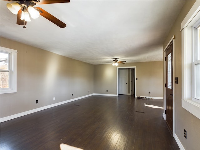 spare room featuring dark hardwood / wood-style floors and ceiling fan