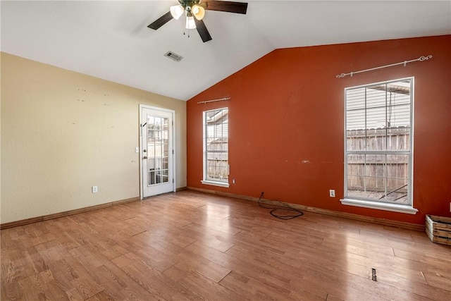 unfurnished room featuring lofted ceiling, hardwood / wood-style floors, plenty of natural light, and ceiling fan