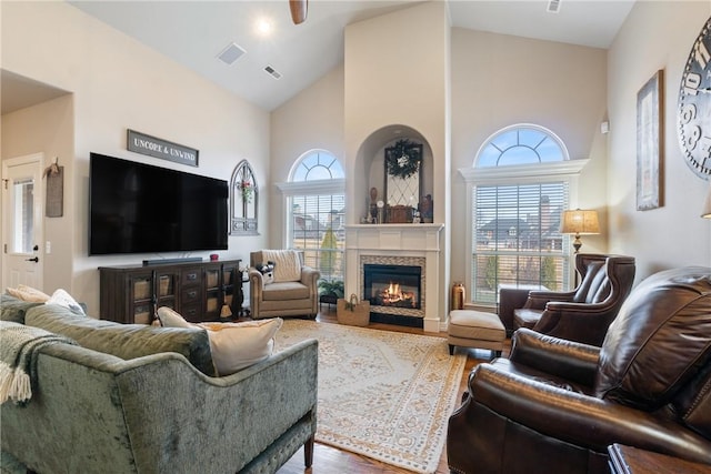 living room featuring hardwood / wood-style flooring and high vaulted ceiling