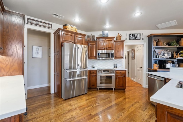 kitchen featuring tasteful backsplash, stainless steel appliances, and dark hardwood / wood-style flooring