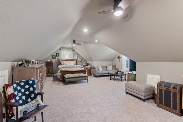 bedroom with carpet floors, ceiling fan, and vaulted ceiling