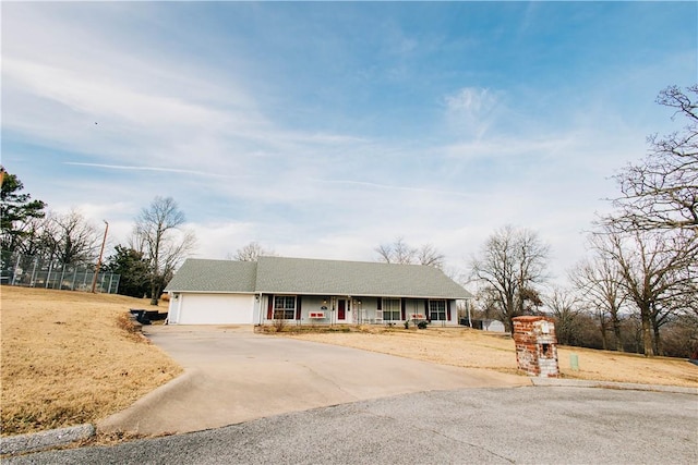 ranch-style home with a porch and a garage