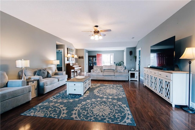 living room with ceiling fan and dark hardwood / wood-style flooring