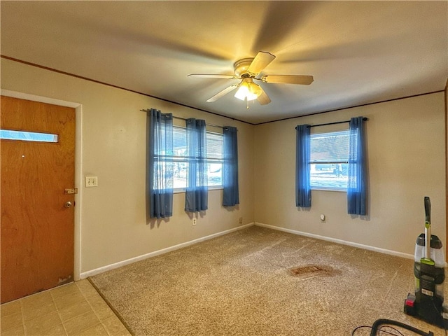 carpeted entrance foyer featuring ceiling fan and plenty of natural light