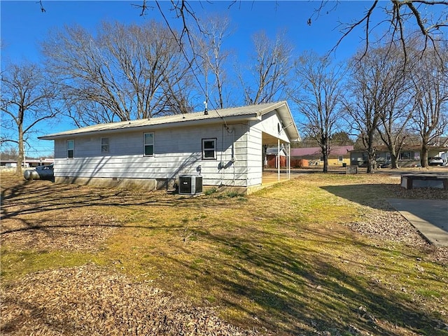 back of house featuring a yard and central air condition unit