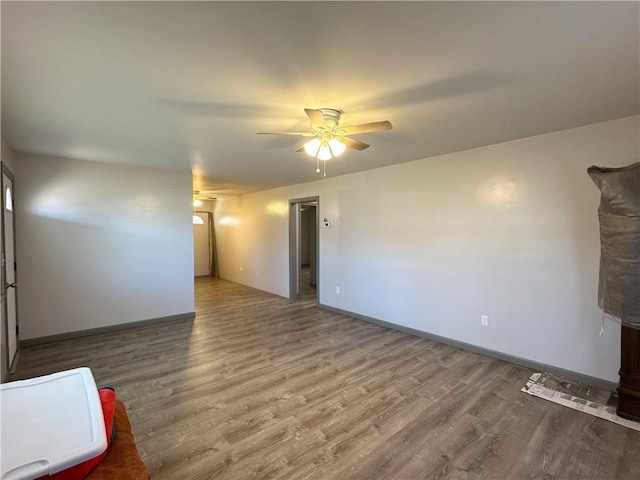 unfurnished living room with ceiling fan and wood-type flooring