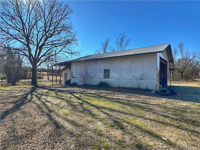 view of side of home with a lawn