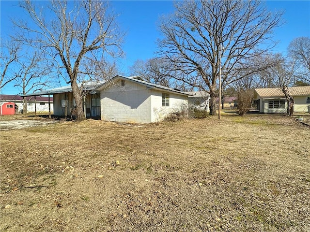 view of property exterior featuring a yard and a carport