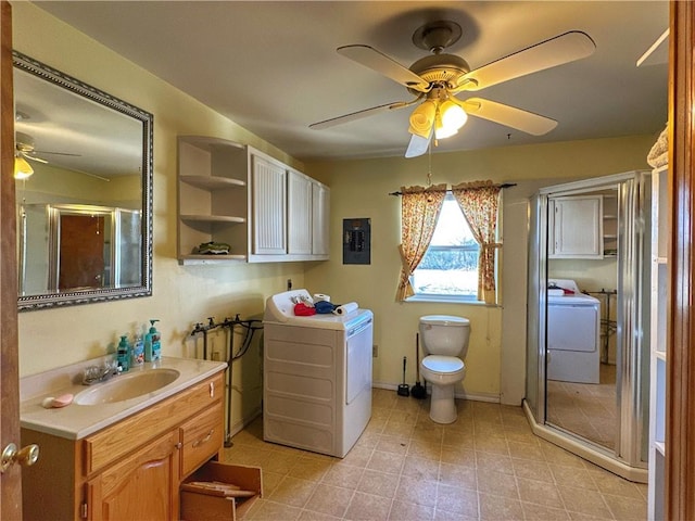 bathroom featuring vanity, washer / dryer, toilet, and walk in shower