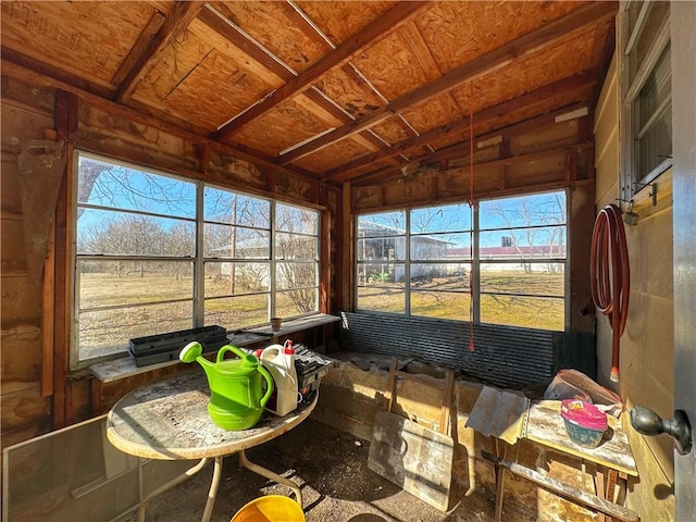 sunroom / solarium featuring vaulted ceiling