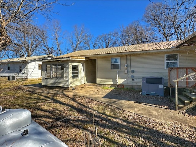 rear view of property featuring central AC and a patio