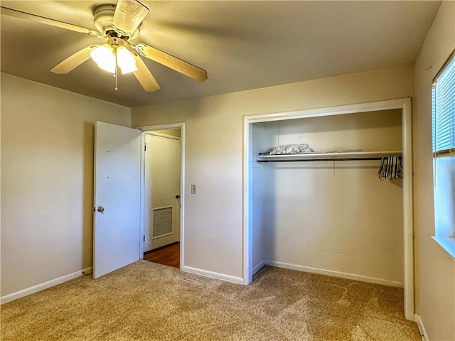 unfurnished bedroom featuring carpet, ceiling fan, and a closet