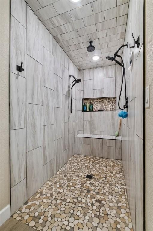 bathroom with a tile shower