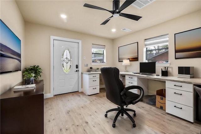 home office with ceiling fan and light hardwood / wood-style flooring