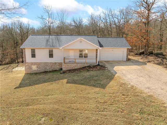 view of front of home featuring a garage, a front yard, and covered porch