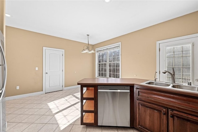 kitchen featuring light tile patterned flooring, decorative light fixtures, dishwasher, sink, and dark brown cabinetry