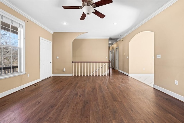 empty room featuring hardwood / wood-style floors, ornamental molding, and ceiling fan