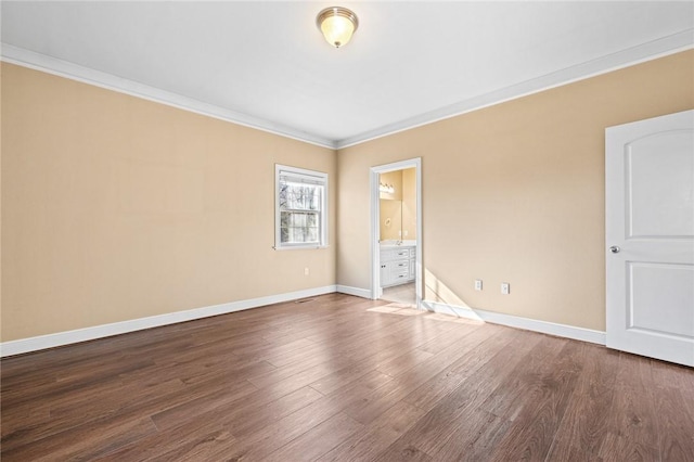 unfurnished room with hardwood / wood-style flooring and crown molding