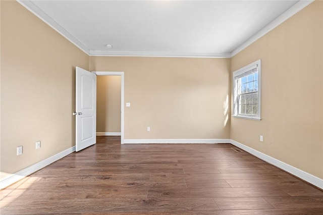 unfurnished room with dark wood-type flooring and ornamental molding