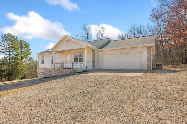 single story home featuring a porch and a garage