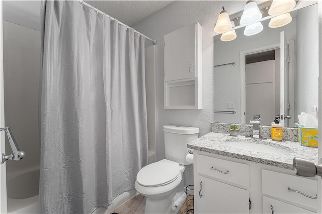 full bathroom with vanity, shower / bath combo, toilet, and a textured ceiling