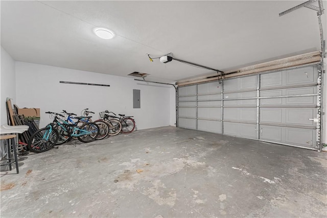 garage with a garage door opener and electric panel