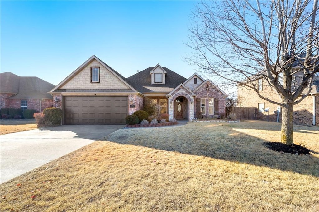 view of front of home featuring a garage and a front lawn