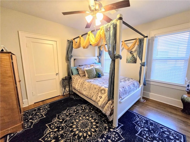 bedroom with dark wood-type flooring and ceiling fan