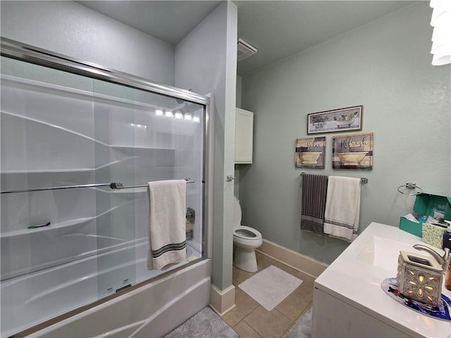 full bathroom with tile patterned flooring, vanity, toilet, and combined bath / shower with glass door