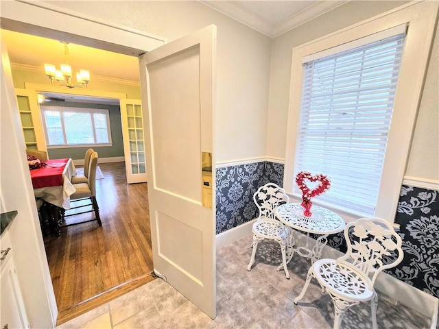 dining area featuring crown molding and an inviting chandelier