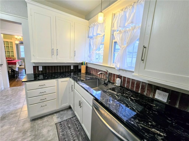 kitchen featuring white cabinetry, dishwasher, and decorative light fixtures