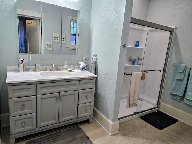 bathroom with tile patterned flooring, vanity, and an enclosed shower