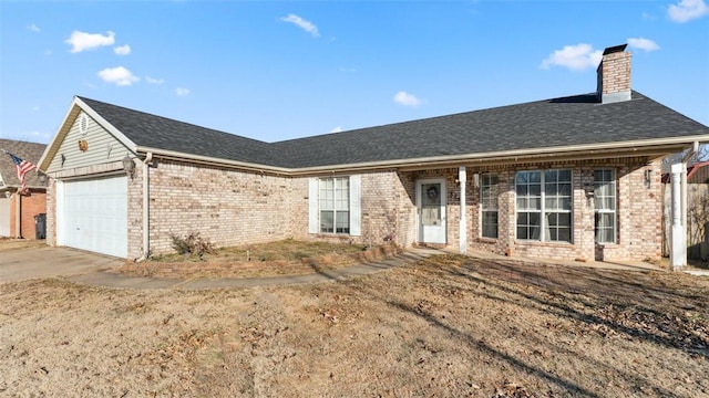 ranch-style house featuring a garage and a front lawn