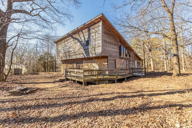 back of property featuring a wooden deck