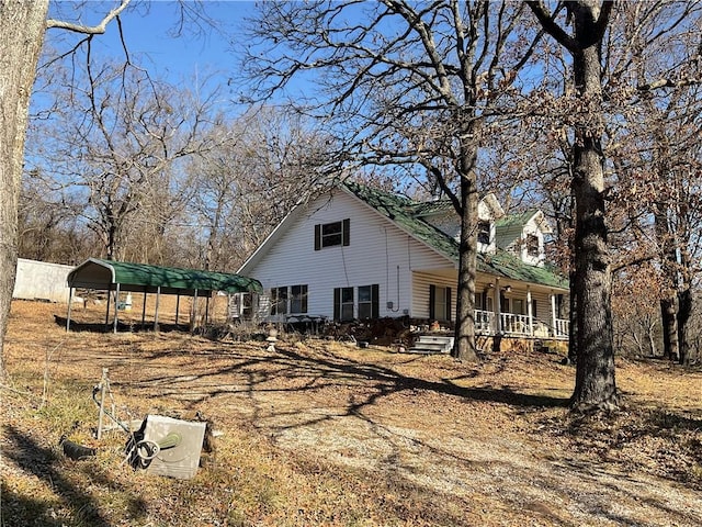 back of house with a carport and a porch