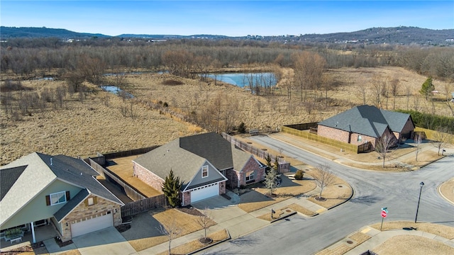 drone / aerial view featuring a water and mountain view