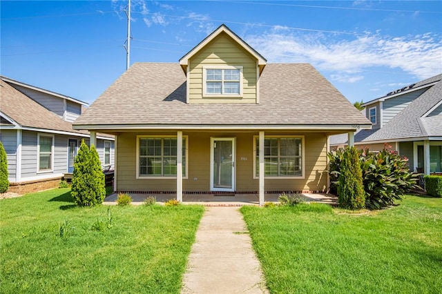 view of front of house featuring covered porch and a front yard