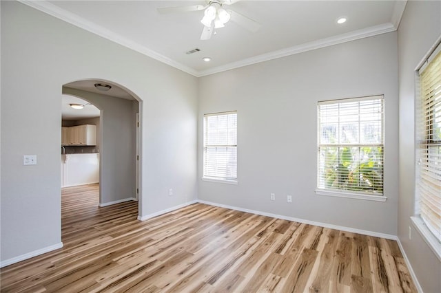 spare room with ceiling fan, ornamental molding, and light hardwood / wood-style floors