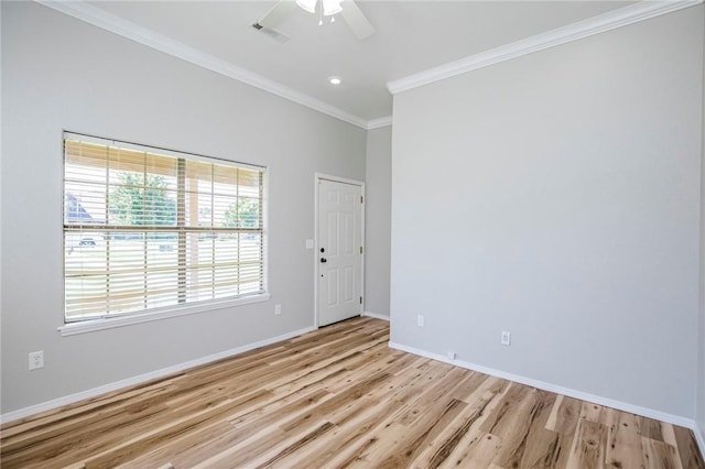 spare room with ceiling fan, ornamental molding, and light hardwood / wood-style flooring