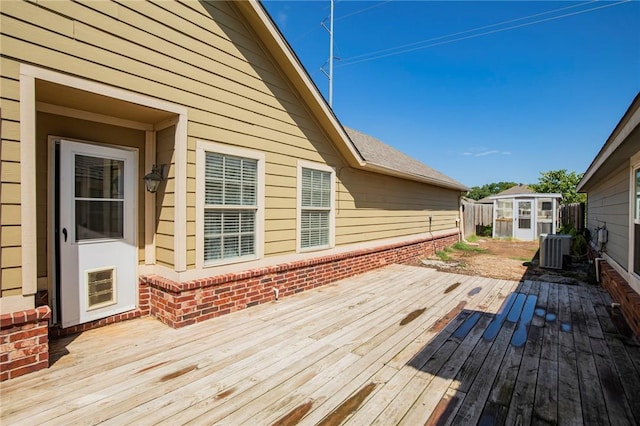 deck featuring a storage shed and central air condition unit