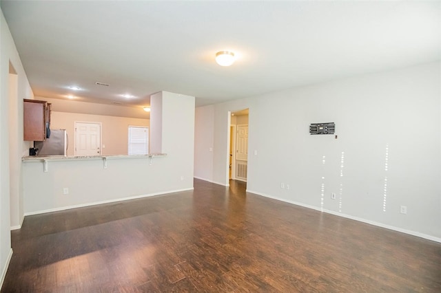 unfurnished living room featuring dark hardwood / wood-style flooring