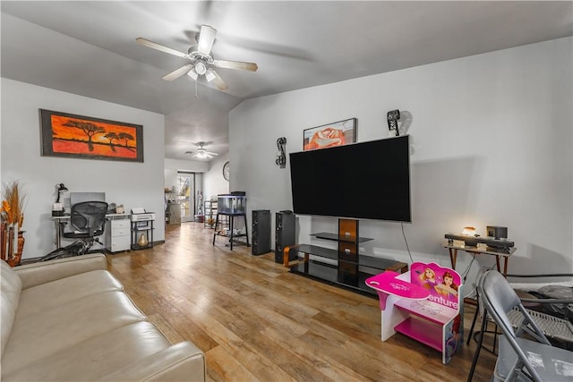 living room with hardwood / wood-style flooring, vaulted ceiling, and ceiling fan