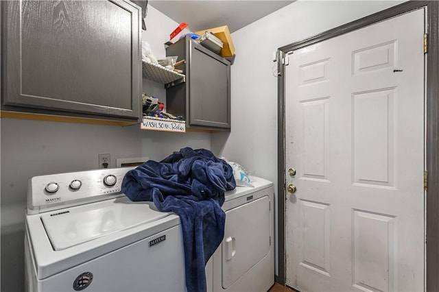 washroom featuring cabinets and separate washer and dryer